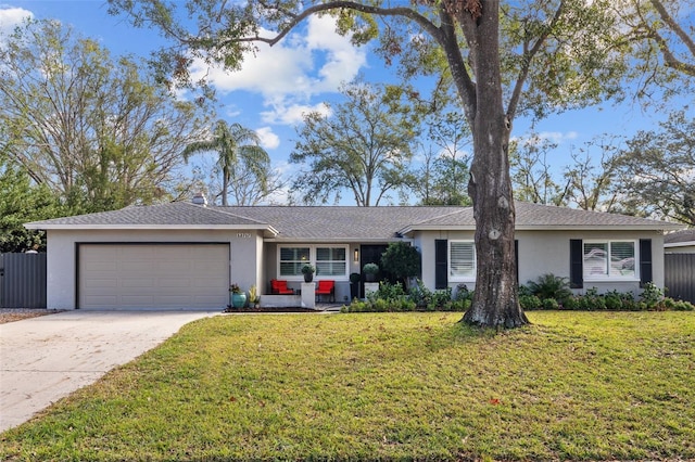 single story home featuring a garage and a front lawn