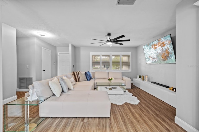 living room featuring hardwood / wood-style flooring and ceiling fan