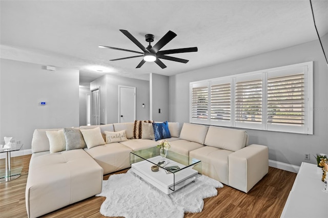 living room with ceiling fan and wood-type flooring