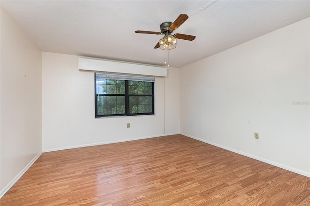 spare room featuring ceiling fan and light hardwood / wood-style flooring