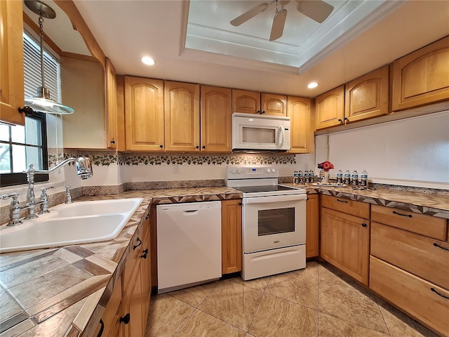 kitchen with sink, crown molding, ceiling fan, a raised ceiling, and white appliances