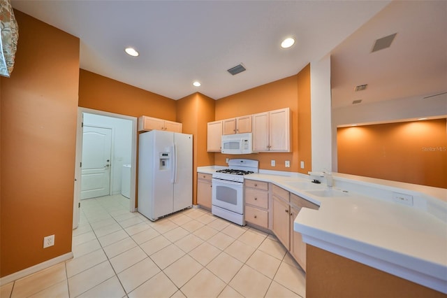 kitchen featuring light tile patterned flooring, sink, light brown cabinets, and white appliances