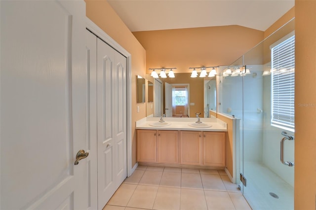 bathroom with tile patterned floors, lofted ceiling, an enclosed shower, and vanity