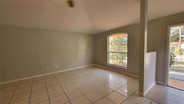 spare room with light tile patterned floors and plenty of natural light