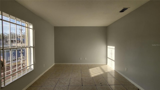 tiled empty room with a healthy amount of sunlight