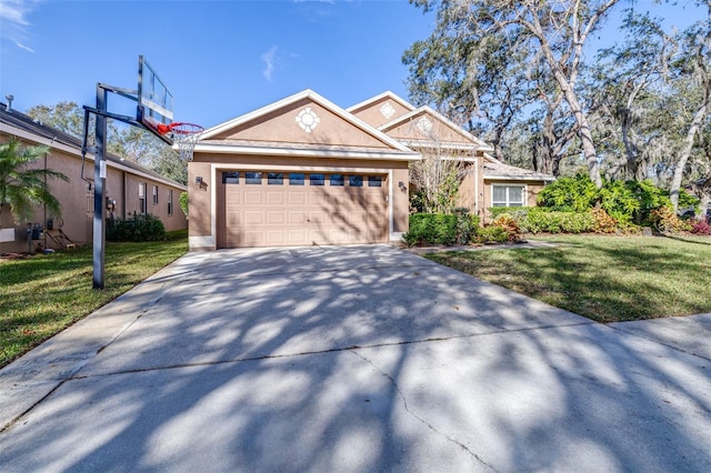 view of front facade with a garage and a front lawn