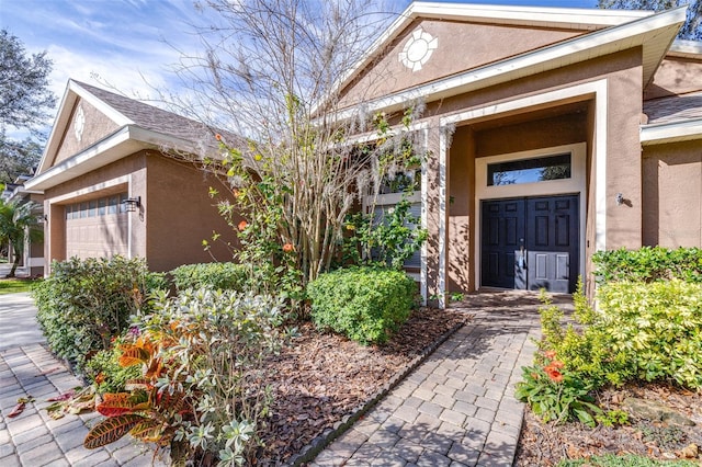 view of exterior entry featuring a garage