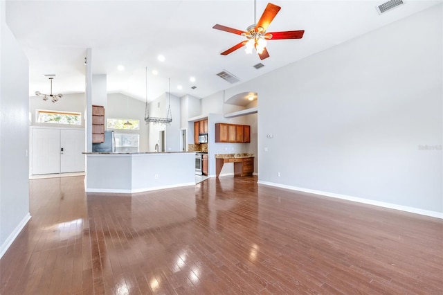 unfurnished living room featuring high vaulted ceiling, ceiling fan with notable chandelier, and dark hardwood / wood-style flooring