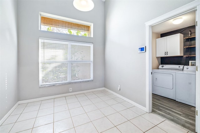 laundry area featuring cabinets, plenty of natural light, and washing machine and dryer