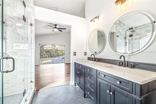 bathroom featuring vanity, a shower with door, ceiling fan, and lofted ceiling