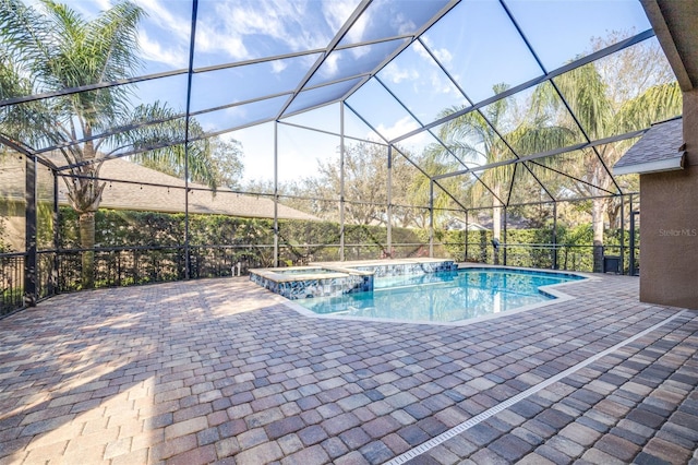 view of pool featuring a lanai, a patio area, and an in ground hot tub