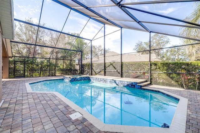 view of swimming pool featuring an in ground hot tub, a lanai, and a patio