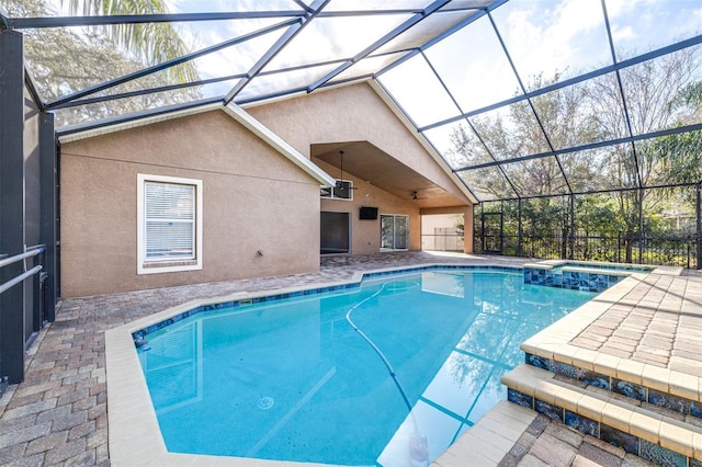 view of pool with a patio and glass enclosure