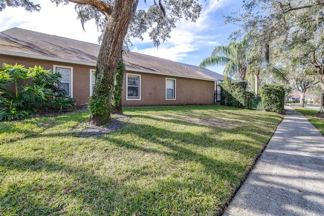 view of home's exterior with a yard