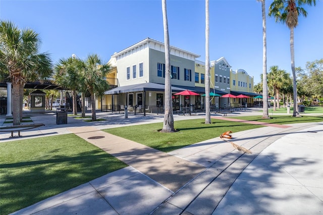 view of property's community with a lawn