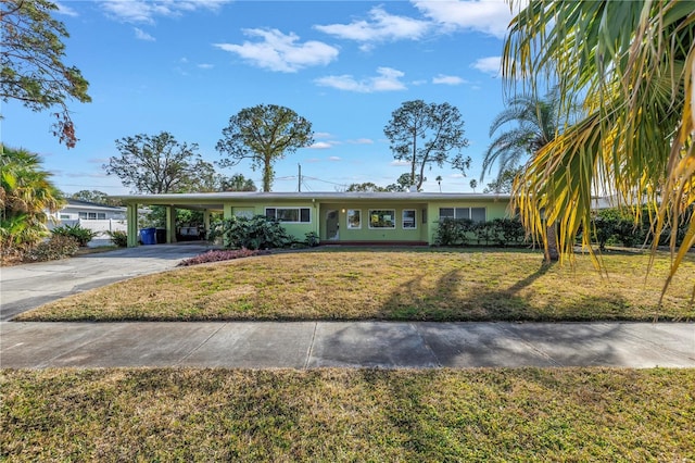 single story home with a front yard, concrete driveway, an attached carport, and stucco siding