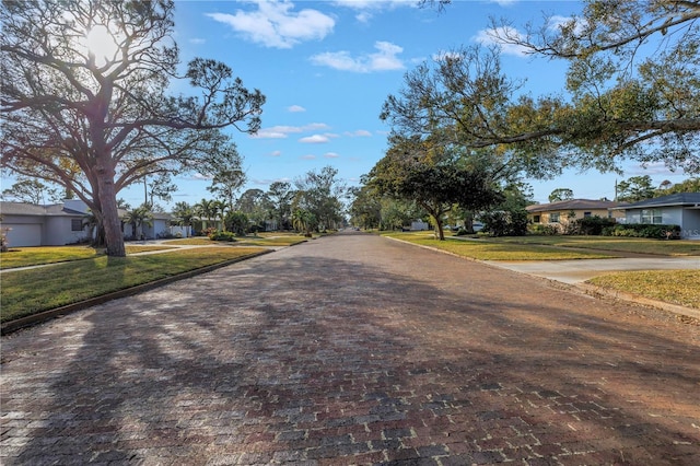 view of road with a residential view and curbs