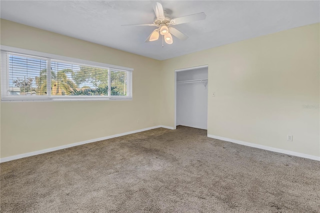 unfurnished bedroom with carpet floors, a ceiling fan, baseboards, and a closet