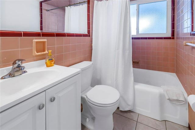 full bathroom featuring shower / tub combo with curtain, toilet, tile walls, vanity, and tile patterned flooring