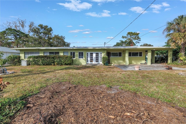 view of front of property featuring a patio, a front lawn, and french doors