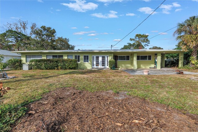 view of front of home featuring a front yard and french doors