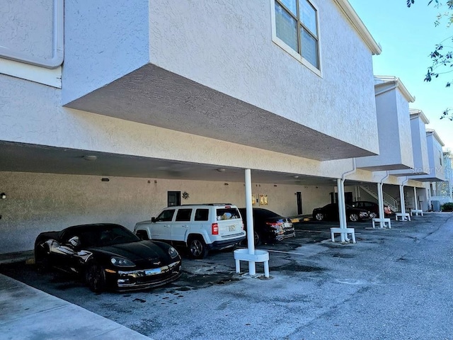 view of vehicle parking featuring a carport