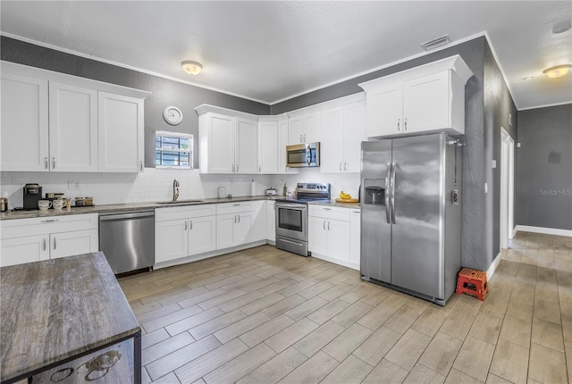 kitchen with appliances with stainless steel finishes and white cabinets