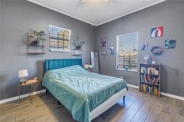 bedroom with multiple windows, crown molding, and ceiling fan