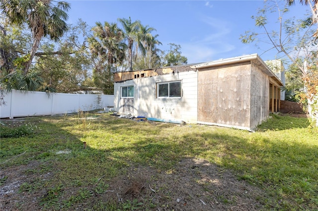 rear view of property featuring a yard