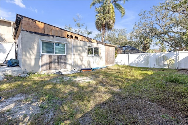 back of property featuring a yard