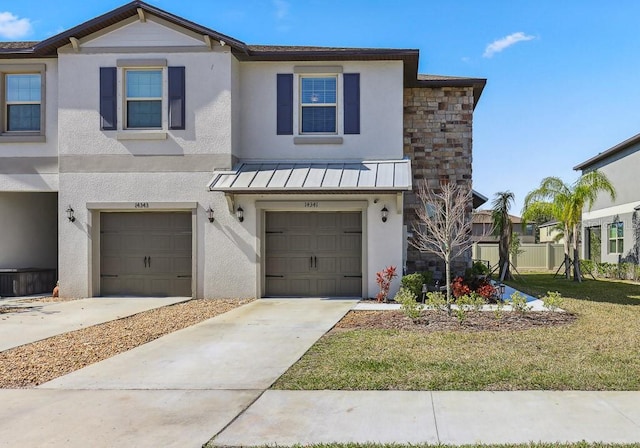 view of front of house with a garage and a front lawn