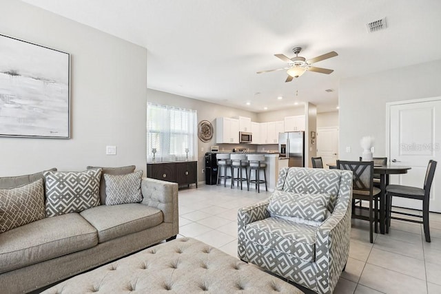 tiled living room featuring ceiling fan