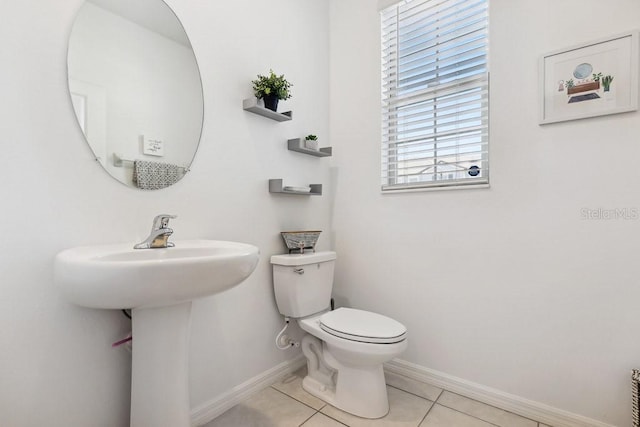 bathroom featuring tile patterned flooring and toilet