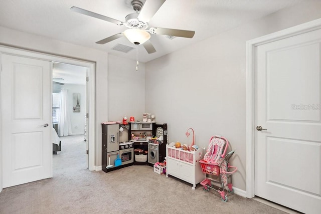 game room with light colored carpet and ceiling fan