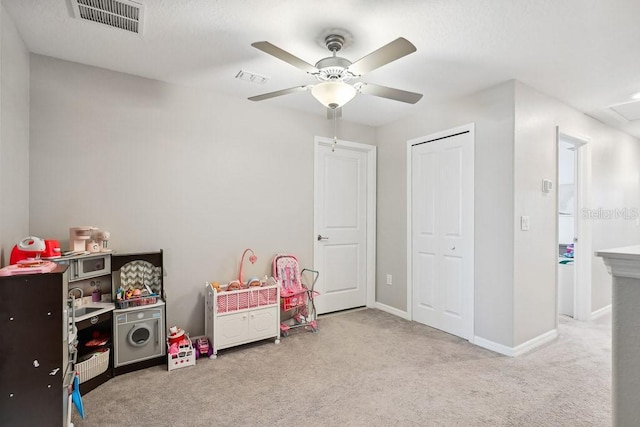 rec room featuring light colored carpet and ceiling fan