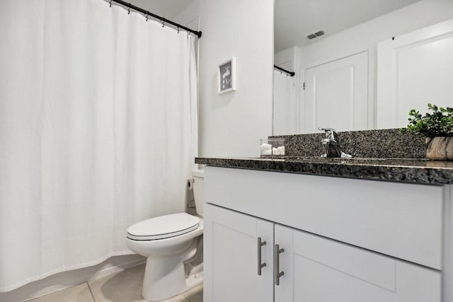 bathroom with vanity, tile patterned floors, and toilet