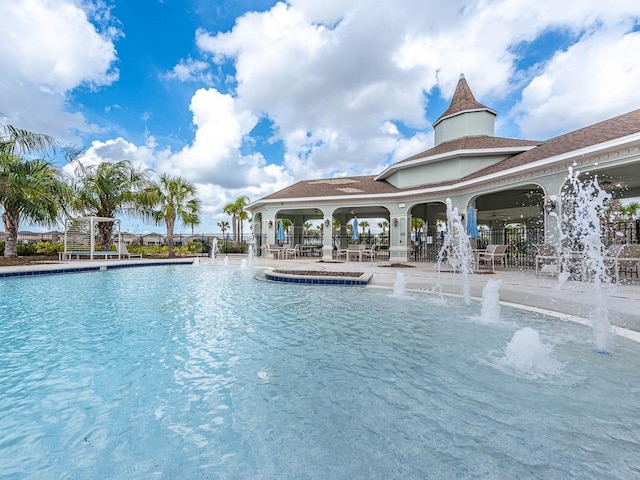 view of pool with a patio area and pool water feature