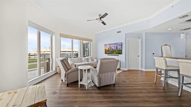 living room featuring dark wood-type flooring, ceiling fan, and ornamental molding