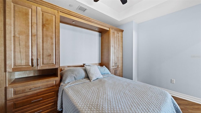 bedroom with dark wood-type flooring and ceiling fan