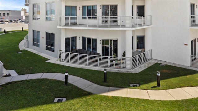 rear view of house featuring a yard