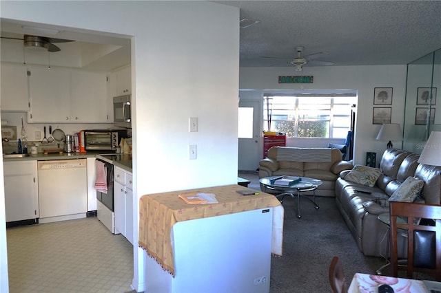 kitchen featuring ceiling fan, white appliances, a textured ceiling, and white cabinets