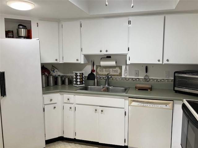 kitchen featuring white cabinetry, sink, and white appliances