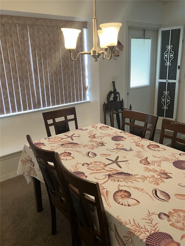 carpeted dining room with an inviting chandelier