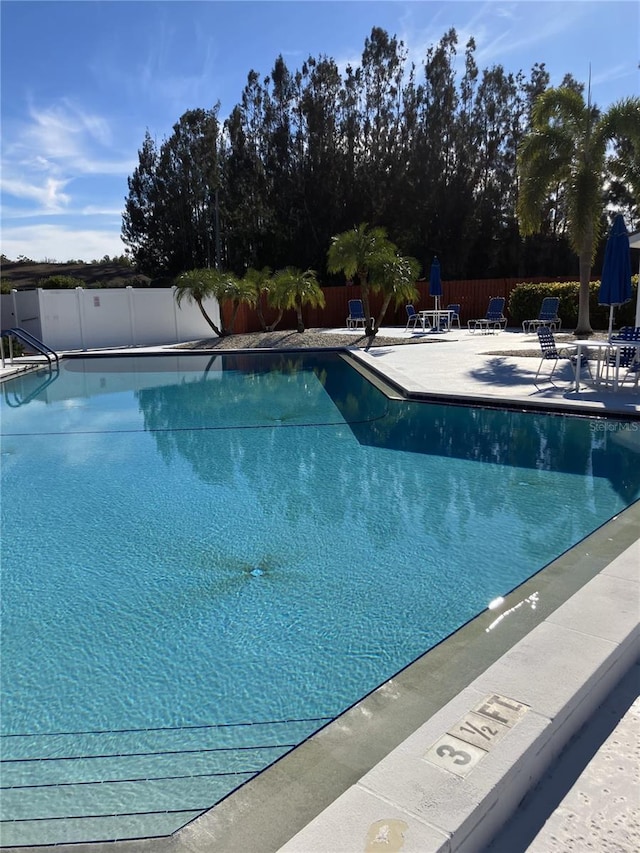 view of swimming pool featuring a patio area