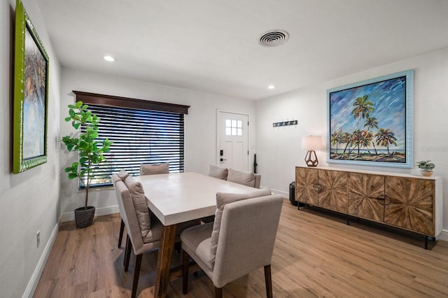 dining space featuring light wood-type flooring