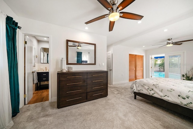 carpeted bedroom with sink, access to outside, ceiling fan, ensuite bath, and a closet