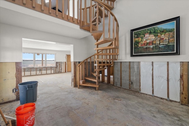 staircase featuring concrete floors