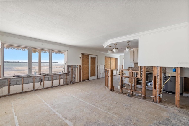 interior space with ornamental molding and a textured ceiling