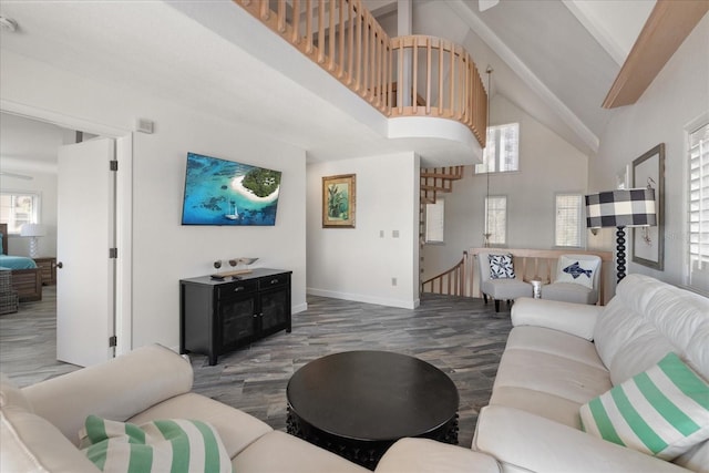 living room featuring beam ceiling and high vaulted ceiling