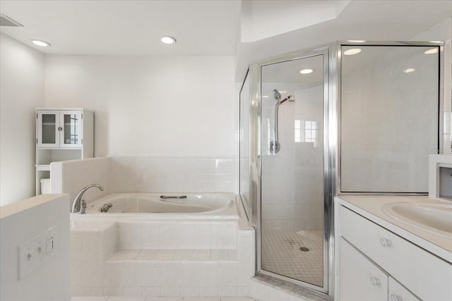 bathroom featuring vanity and shower with separate bathtub